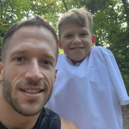 Jaka and his son Tim, smiling in the woods