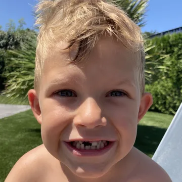 Tim, grinning with a missing front tooth